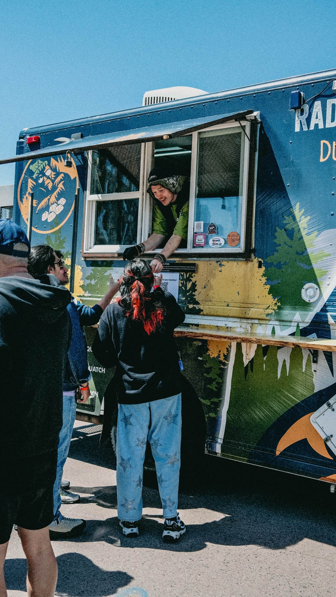 A customer being handed an order at the Radical Sasquatch truck window